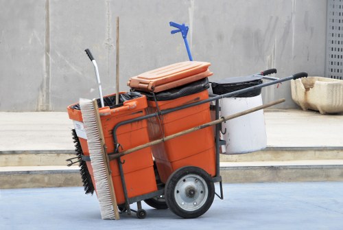 Worker wearing PPE handling waste during skip loading